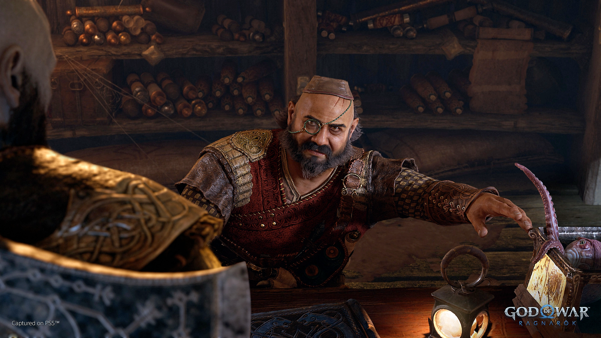 God of War Ragnarök screenshot showing a man in hat and monocle talking to Kratos