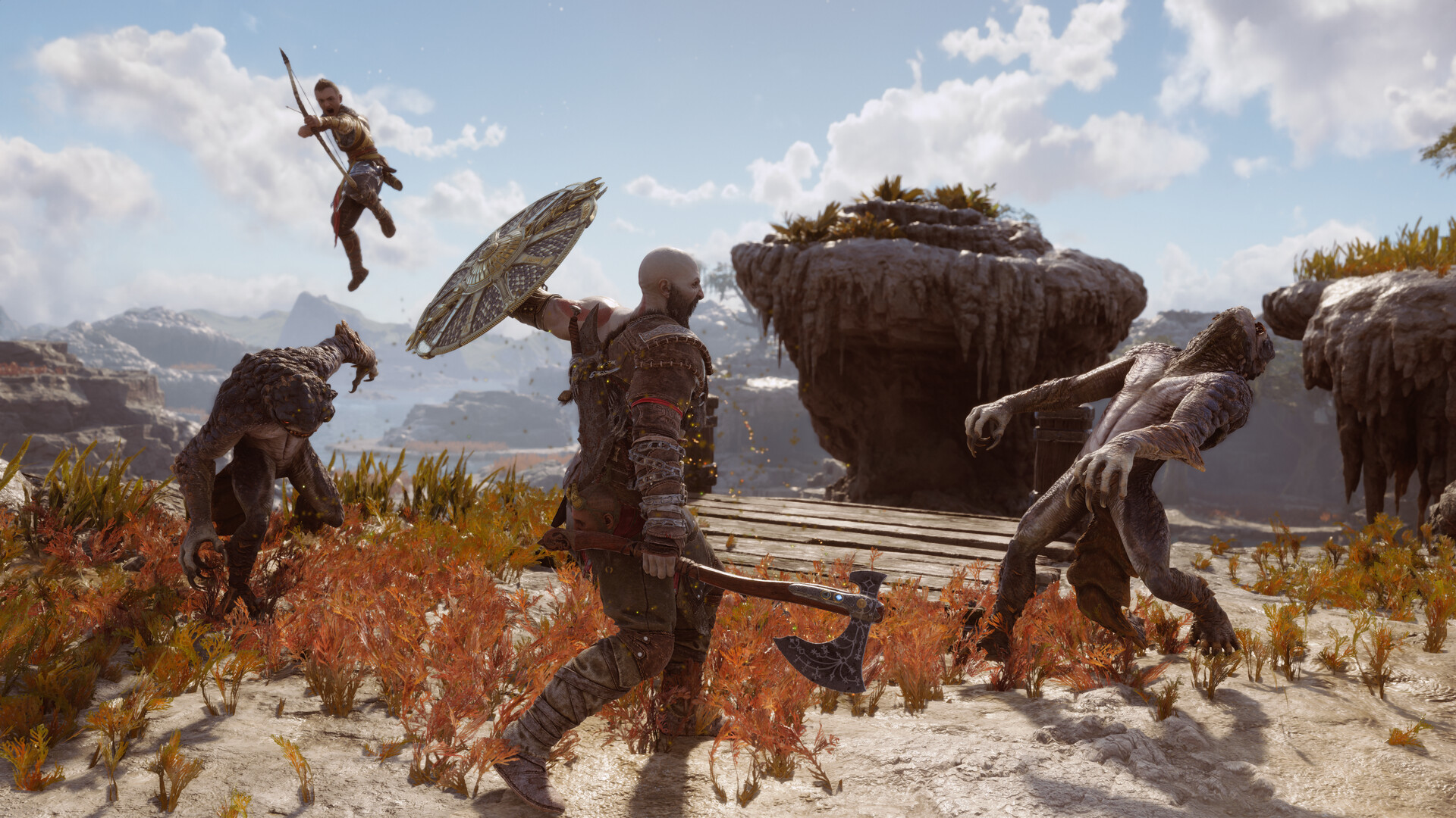 God of War Ragnarök screenshot showing Kratos and Atreus fighting enemies in a desolate landscape